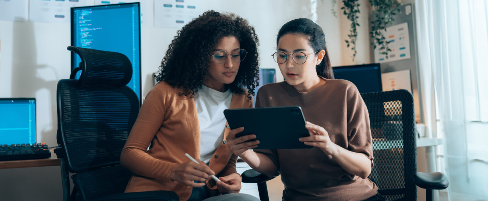 Two business women looking at a tablet