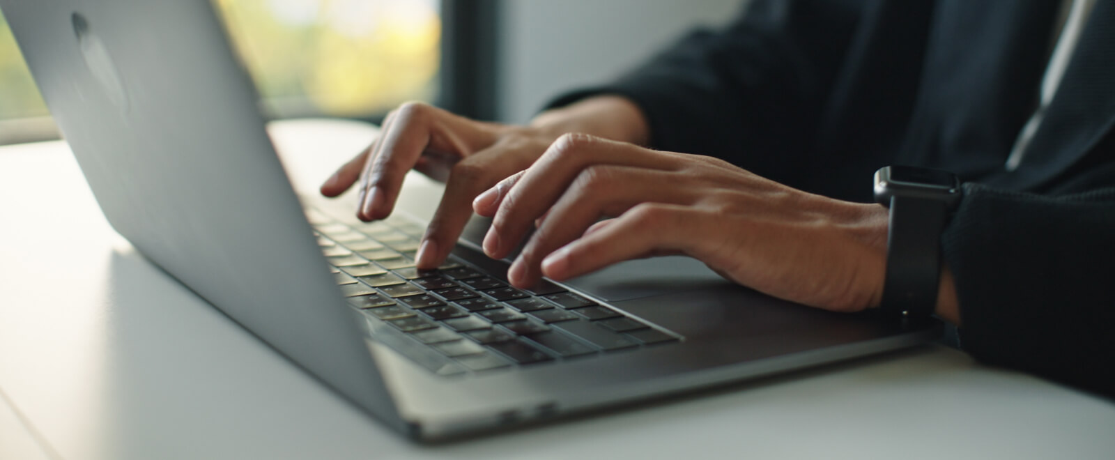 Cose-up of hands typing on a keyboard